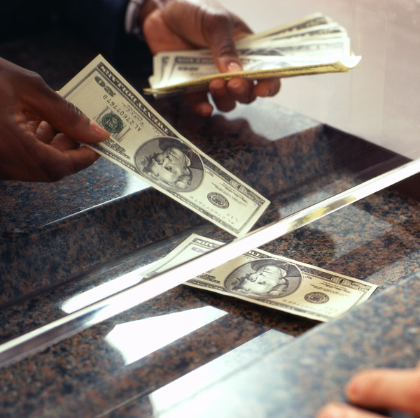 Bank teller counting money